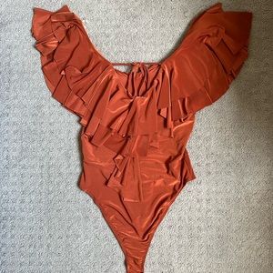 On and off shoulder bodysuit. Size Small. Never worn but without the tag.